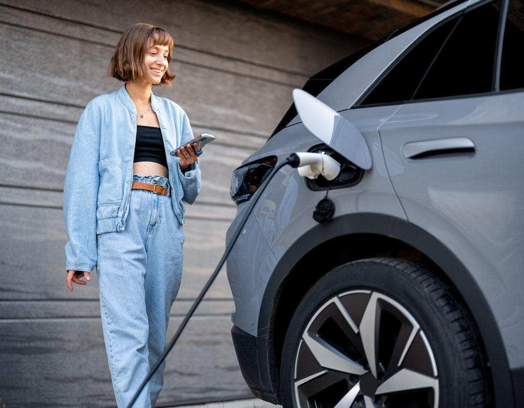 a person standing in front of a car